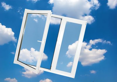 Opened window on blue sky background.